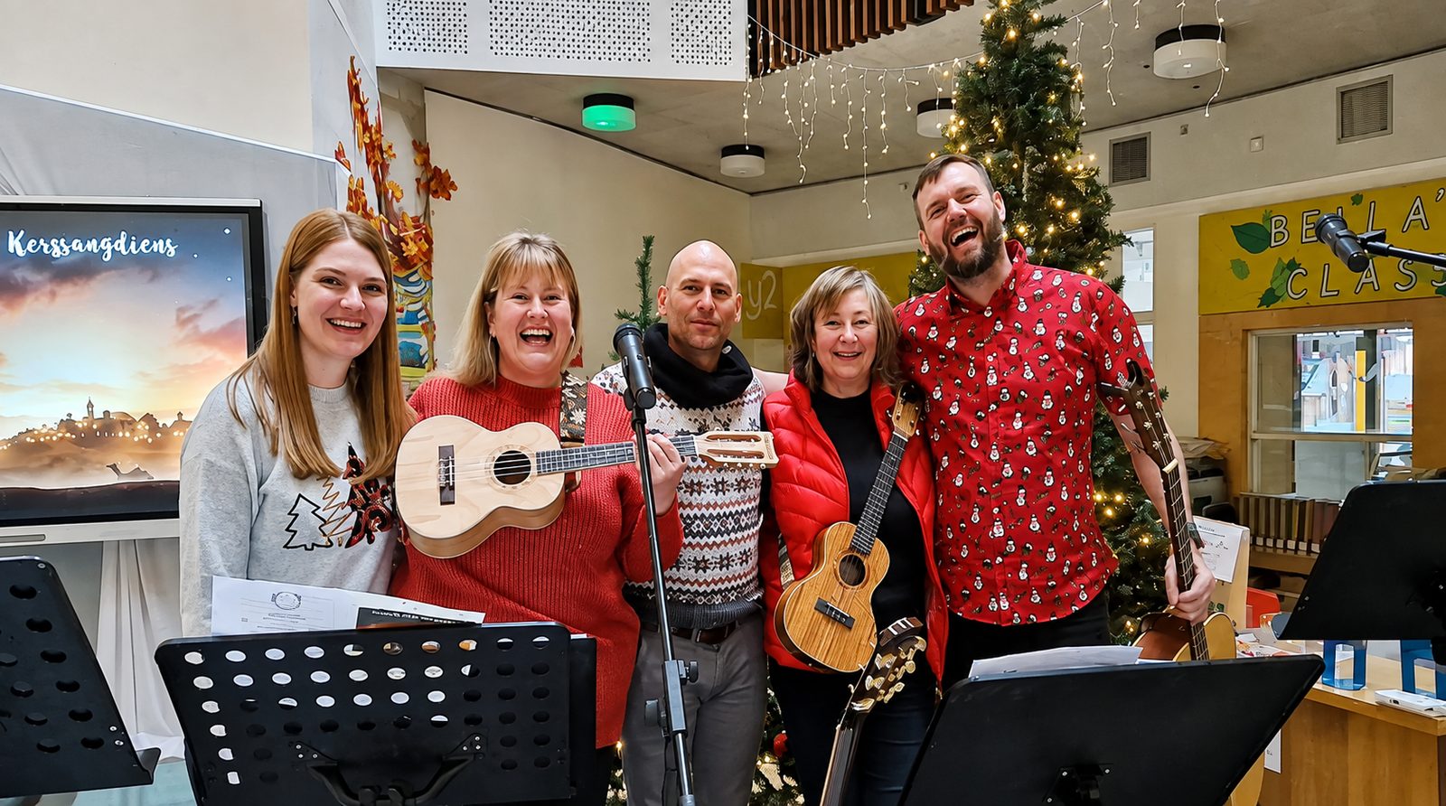 Barry and fellow musicians with ukuleles after a worship performance at a Christmas gathering