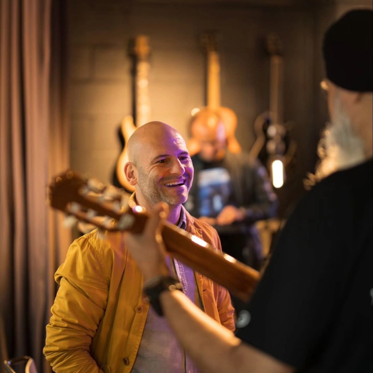 Barry laughing and talking with a fellow musician during a rehearsal