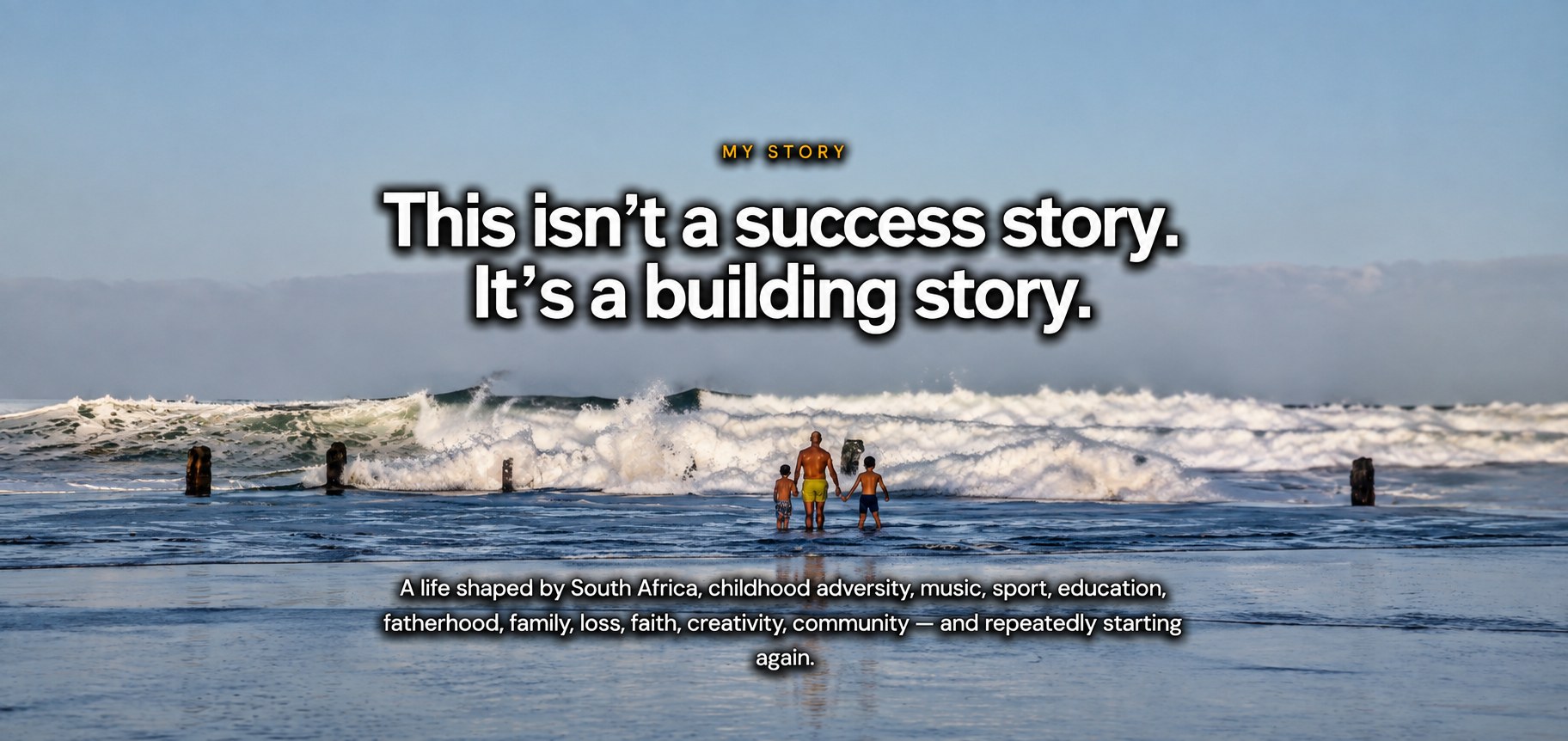 Barry de Jager standing in the ocean with two of his children facing the waves — This isn't a success story. It's a building story.